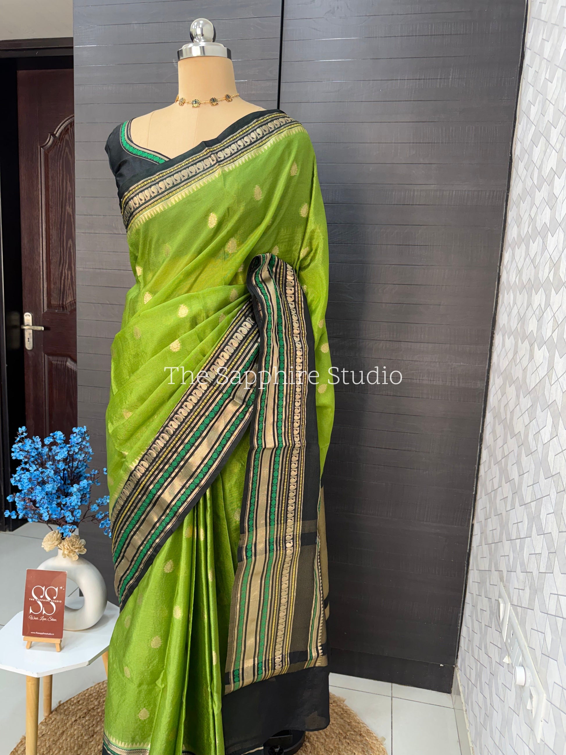 green Banarasi Chiniya silk saree with black zari border and butta work, lightweight festive saree for weddings, pujas and cultural occasions